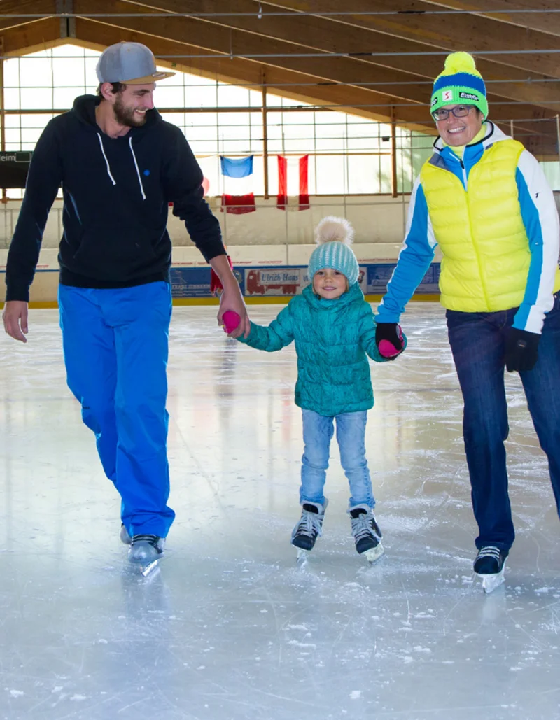 Eine Familie beim Eislaufen in der Eishalle in Pfronten.